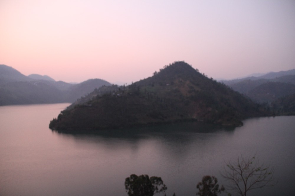 Soft sunrise light over the calm water and hilly islands of Lake Kivu at Kibuye (Karongi), Rwanda.